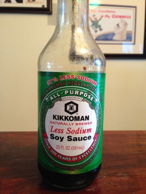 bottle of kikkoman soy sauce on table 