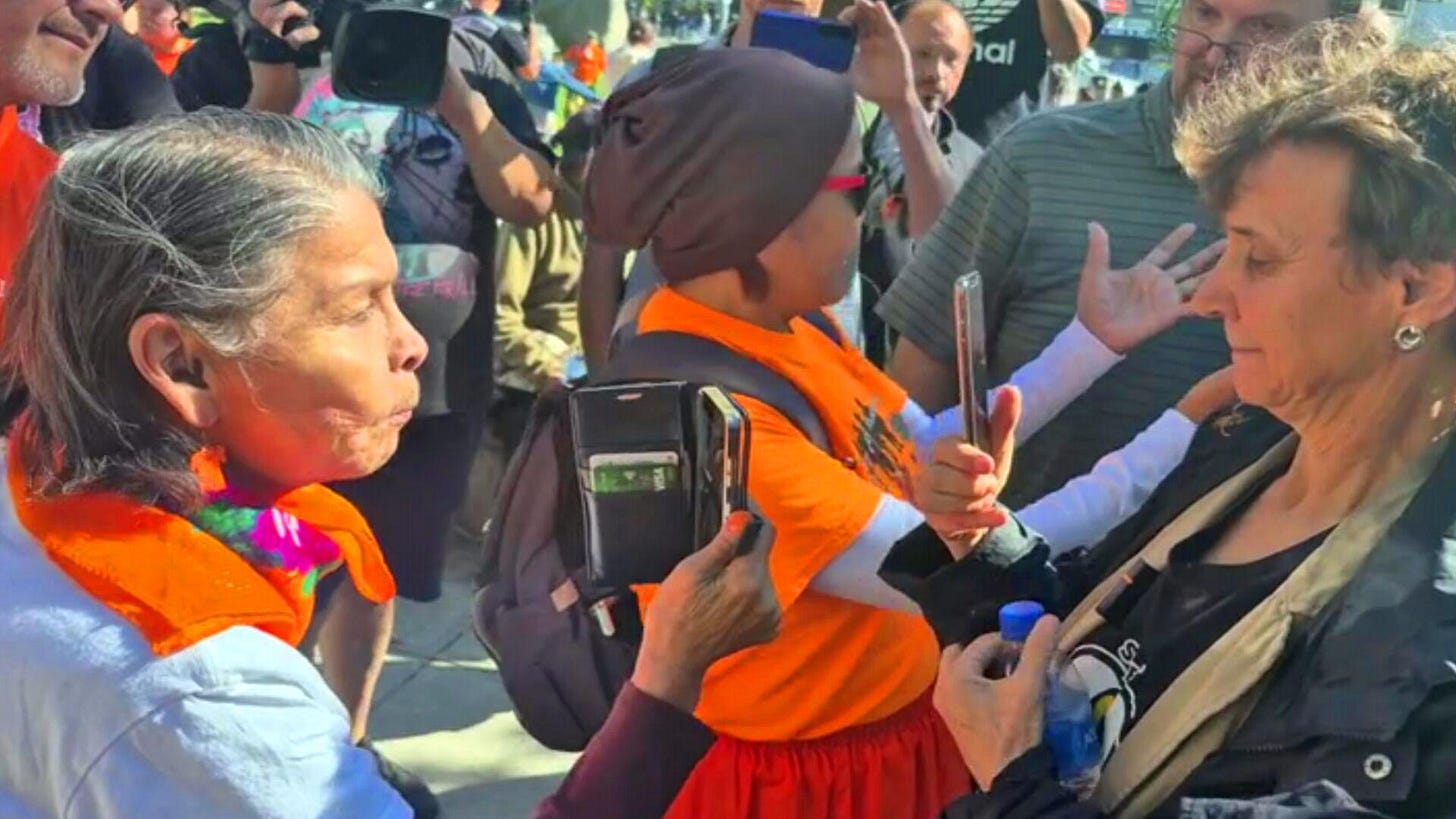 May be an image of 3 people and crowd