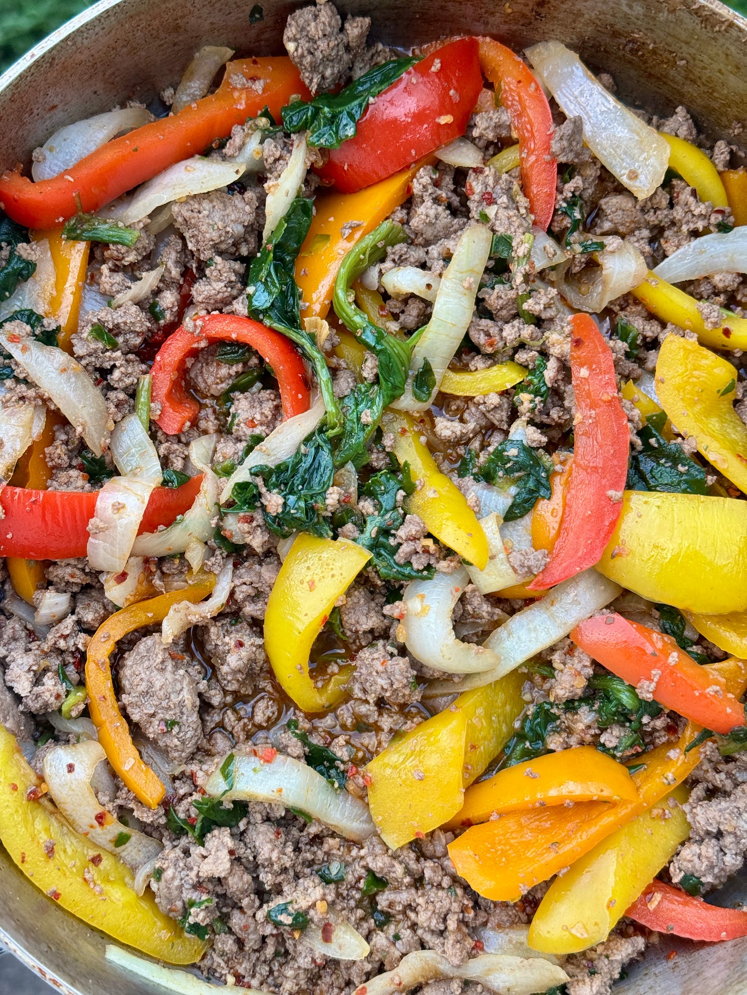 Firecracker beef bowls with red bell peppers, yellow bell peppers, white onion, and beef