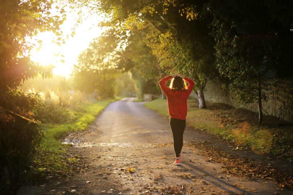 Woman going on a walk in the sunlight to boost vitamin D levels