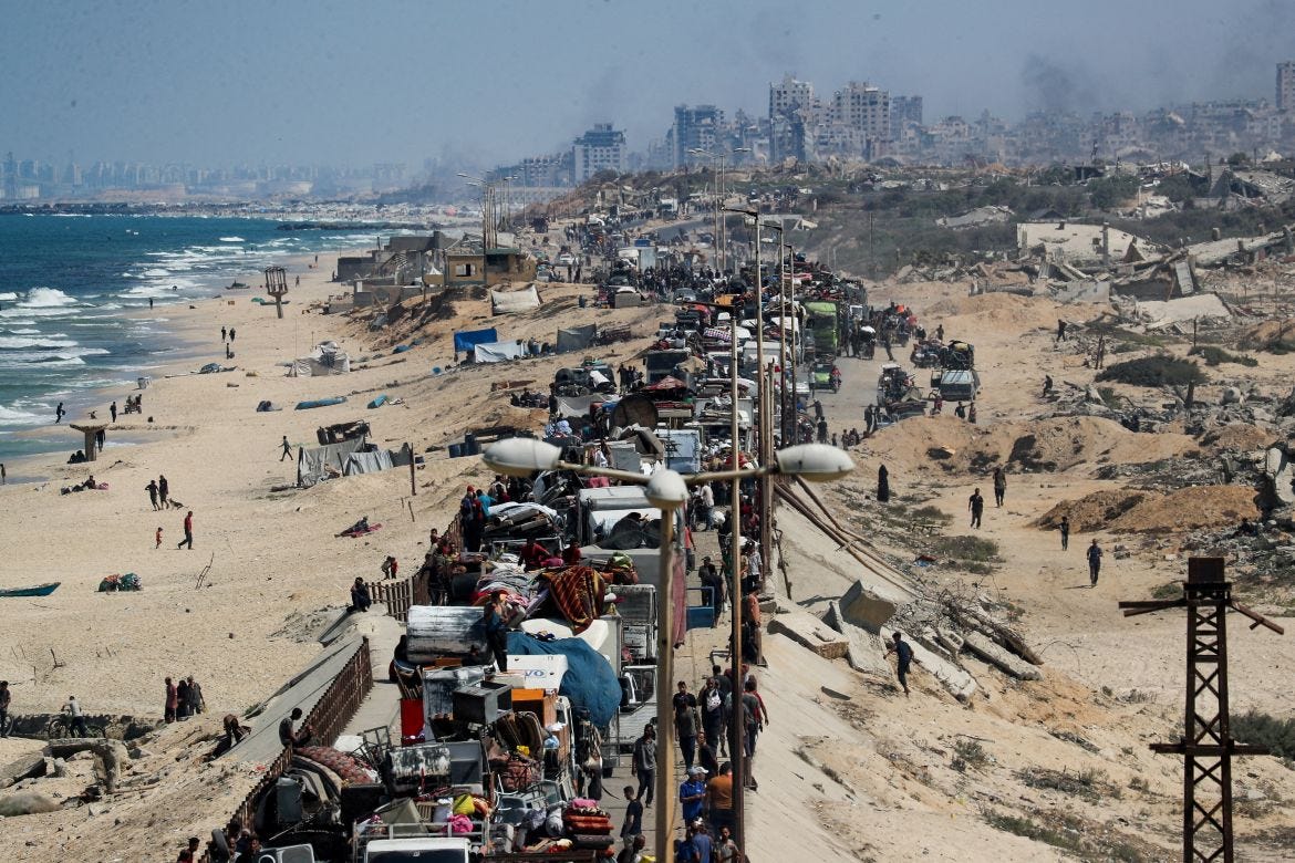 Displaced Palestinians head southwards through the central Gaza Strip after fleeing the north amid an Israeli military operation
