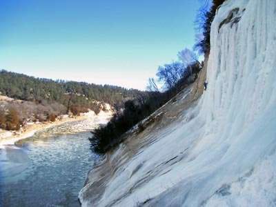 A frozen waterfall next to a river

AI-generated content may be incorrect.