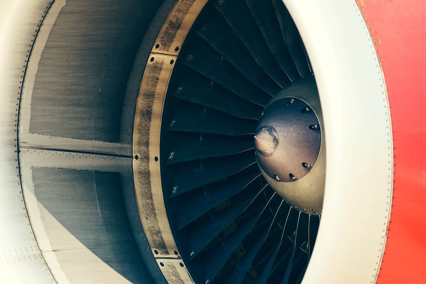 The turbine of an airplane, standing still. It is made of a large fan of metal blades that spin in a circle to pull air. The turbine of an airplane, standing still. It is made of a large fan of metal blades that spin in a circle to pull air.