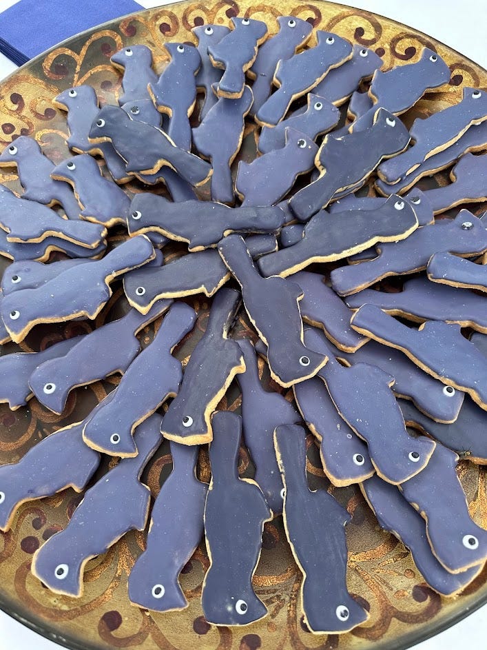 Cookies shaped and colored like purple martin birds. 