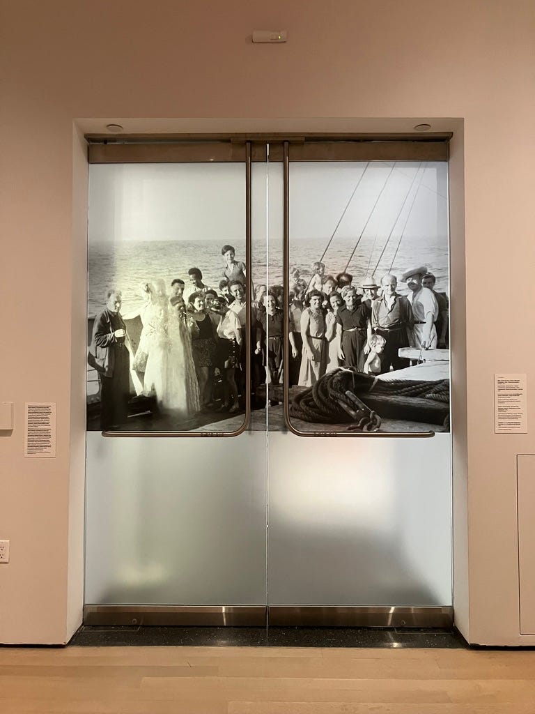 a photograph of a group of people on a boat, displayed on two glass doors a photograph of a group of people on a boat, displayed on two glass doors