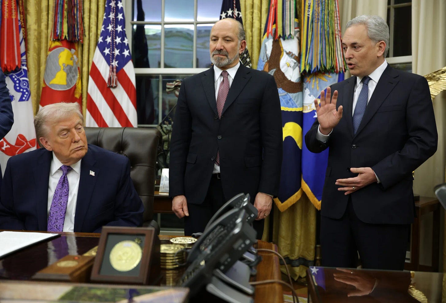 President Donald Trump, left, and Commerce Secretary Howard Lutnick look on as White House AI czar David Sacks speaks in the Oval Office of the White House on December 11 in Washington.