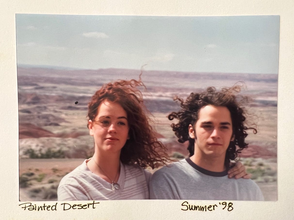 A person and person posing for a picture

Description automatically generated