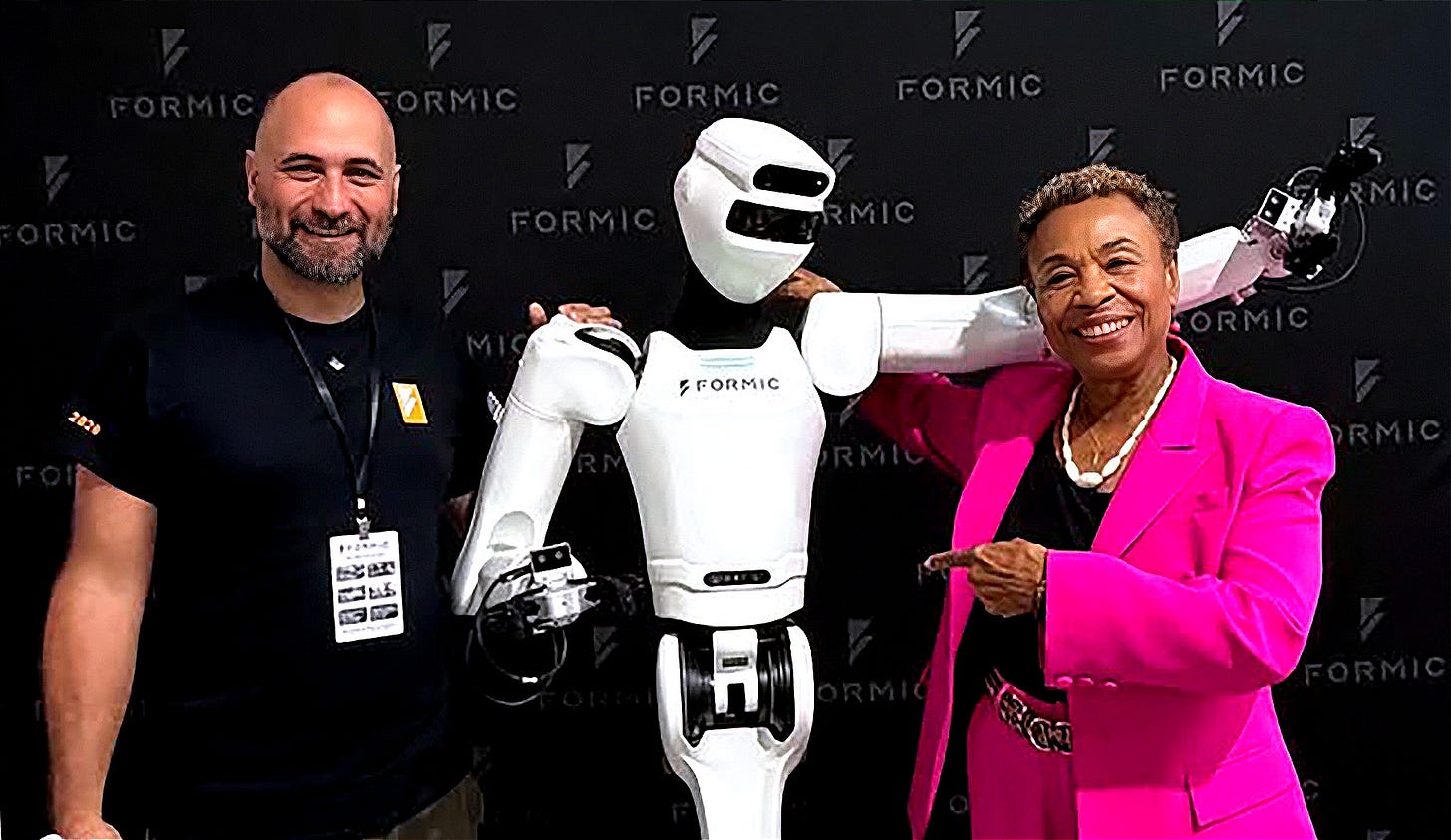 Mayor Barbara Lee poses for a portrait with an AI robot at the opening of Formic’s new manufacturing facility in Oakland on Sept. 2, 2026. (Photo source: Instagram @mayorbarbaralee)