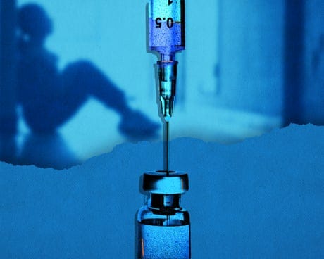 A generic needle and vial with a young person in the background A generic needle and vial with a young person in the background