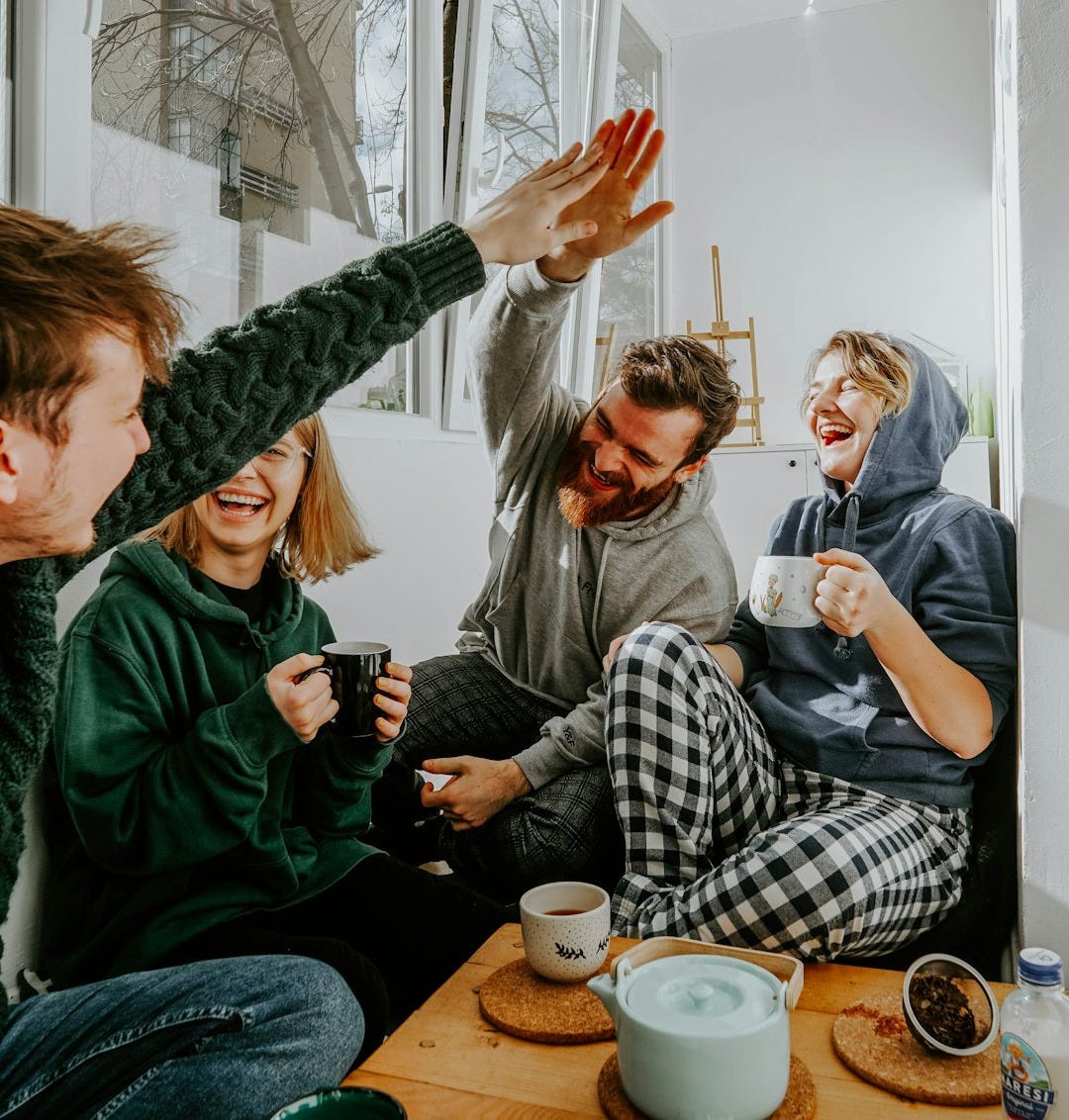 woman in black and white checkered long sleeve shirt sitting beside man in green crew neck woman in black and white checkered long sleeve shirt sitting beside man in green crew neck