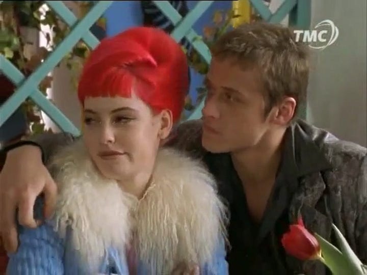 Actor in "tough guy" person with arm around actress with dyed red hair (L), and same actress smiling and holding a plaque commerating her partnership with pygmy hippo.