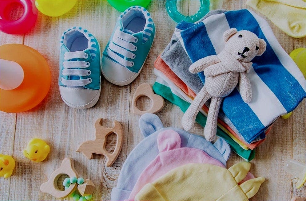a collection of baby clothes and toys