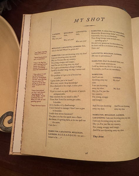 A photo of the cover of the book Hamilton: The Revolution, plus a sampling of pages from Hamilton: The Revolution