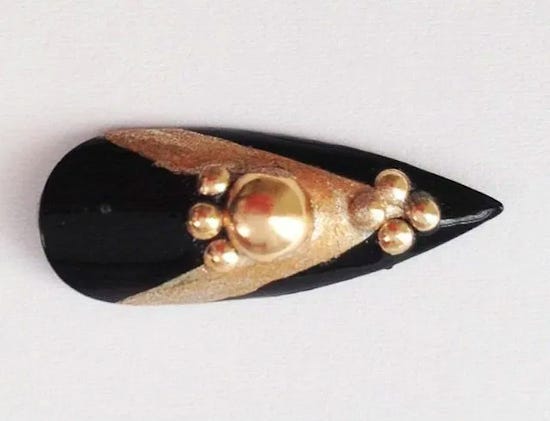 A fake fingernail with fancy decorations