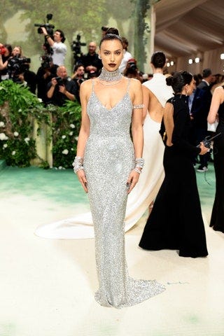 Image may contain Irina Shayk Fashion Clothing Dress Footwear Shoe Adult Person Wedding and Formal Wear