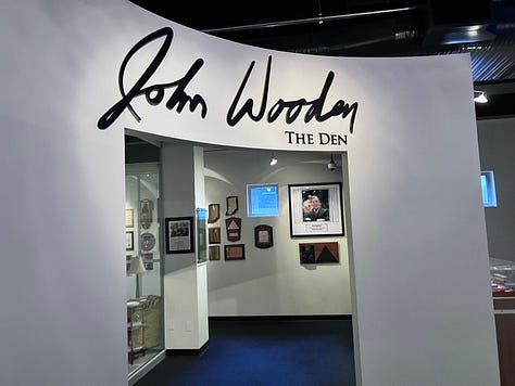 Images of John Wooden, his den, trophies, and author standing by the John Wooden monument