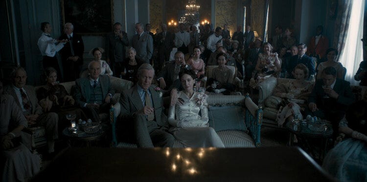David Windsor and his wife Wallis Simpson seated front and center at their coronation viewing party at their home in Paris.