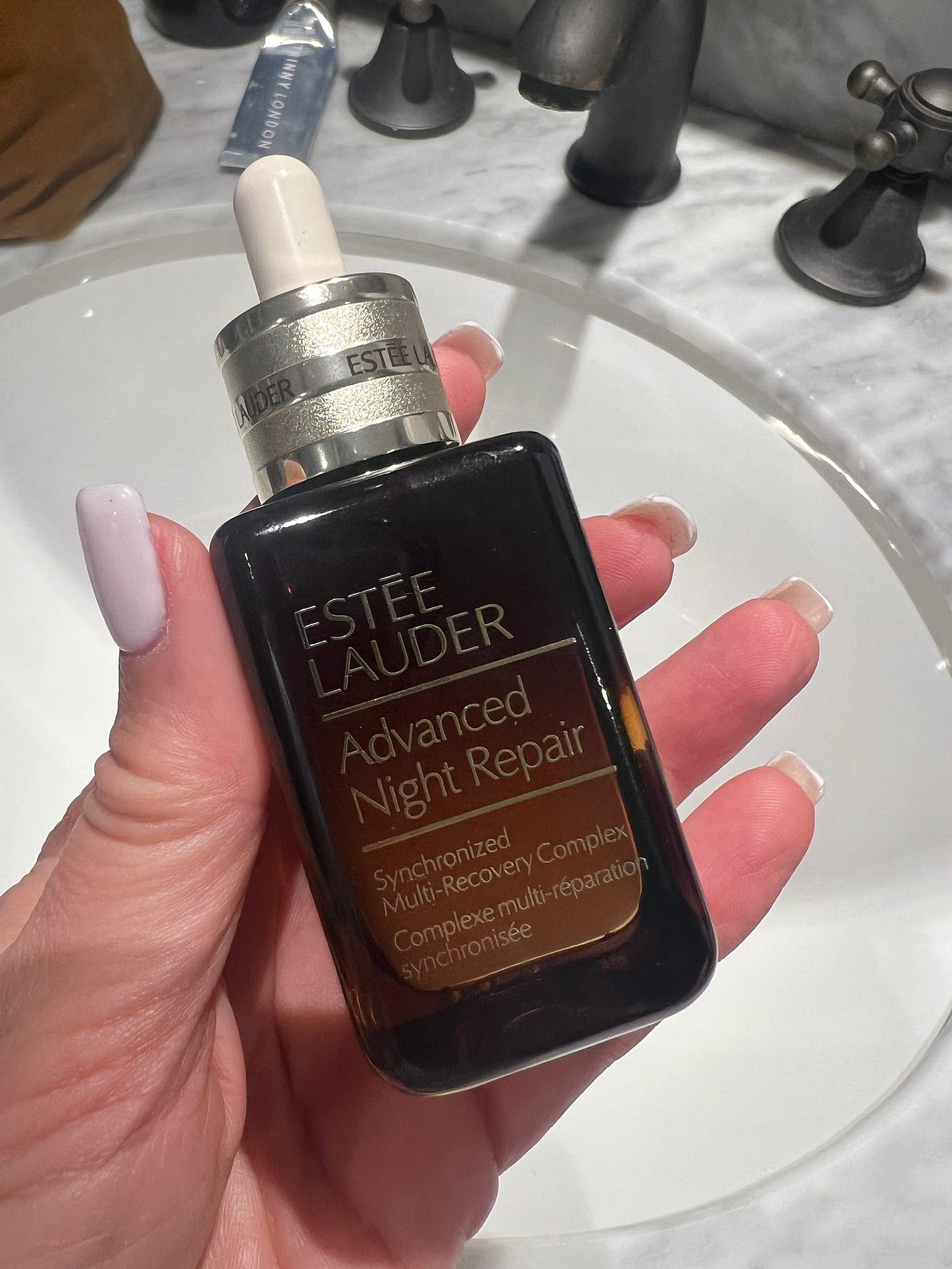 he iconic brown glass bottle of Estée Lauder Advanced Night Repair serum, featuring tripeptide-32 technology for cellular renewal. he iconic brown glass bottle of Estée Lauder Advanced Night Repair serum, featuring tripeptide-32 technology for cellular renewal.