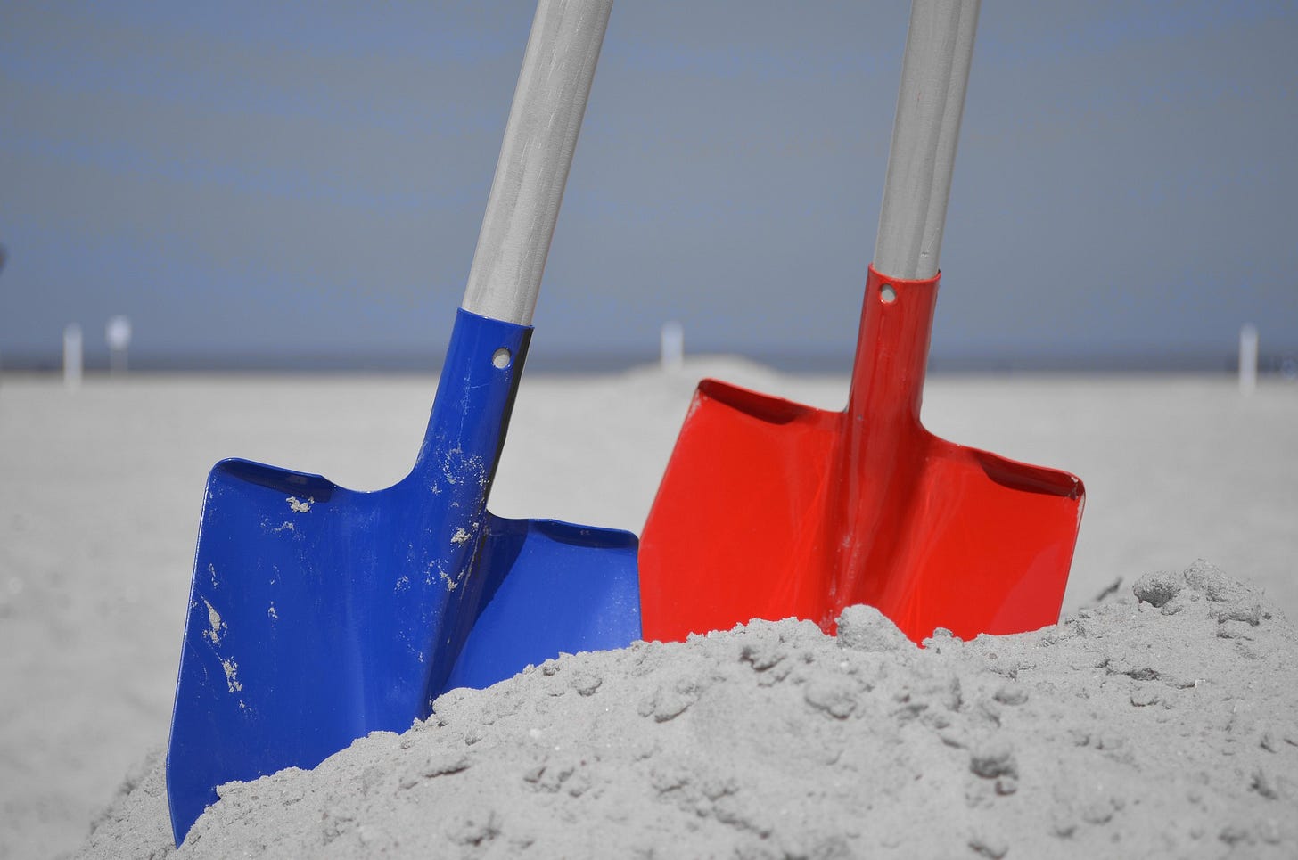 Shovels in sand