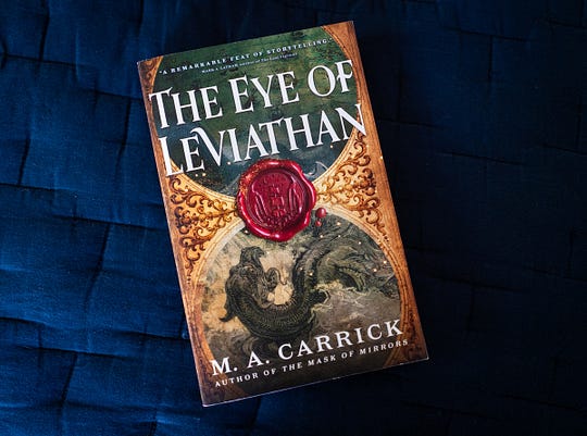 A photograph of M.A. Carrick's book The Eye of Leviathan against a blue background