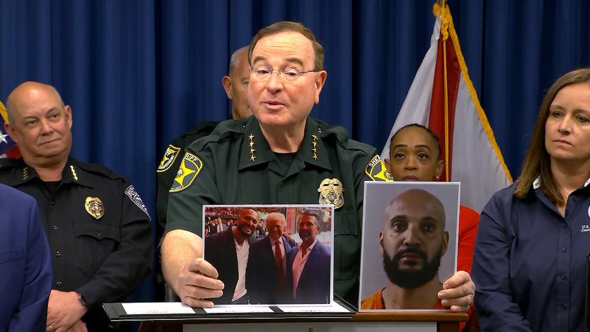 Sheriff Grady Judd holding a booking photo of Craig Long Sheriff Grady Judd holding a booking photo of Craig Long