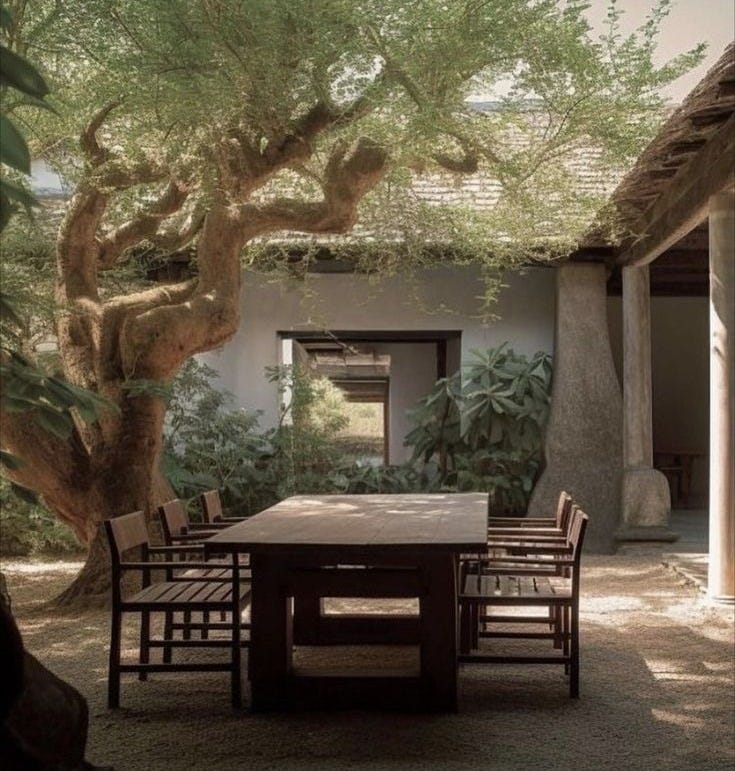 This may contain: an outdoor dining area with table and chairs