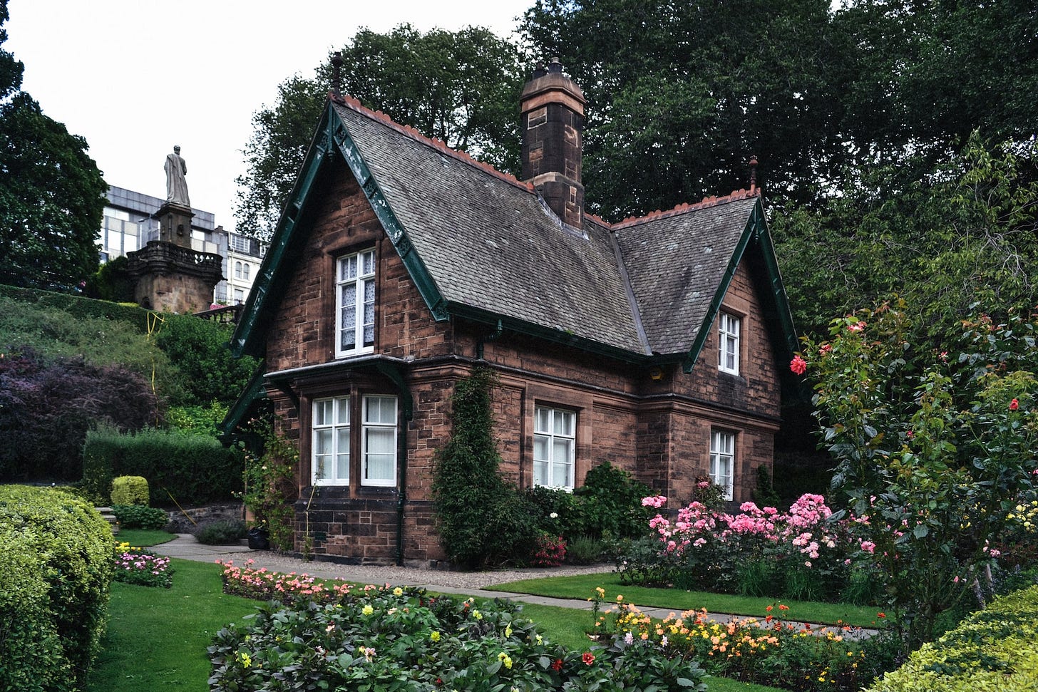 A small cottage house nestled in a garden. A small cottage house nestled in a garden.