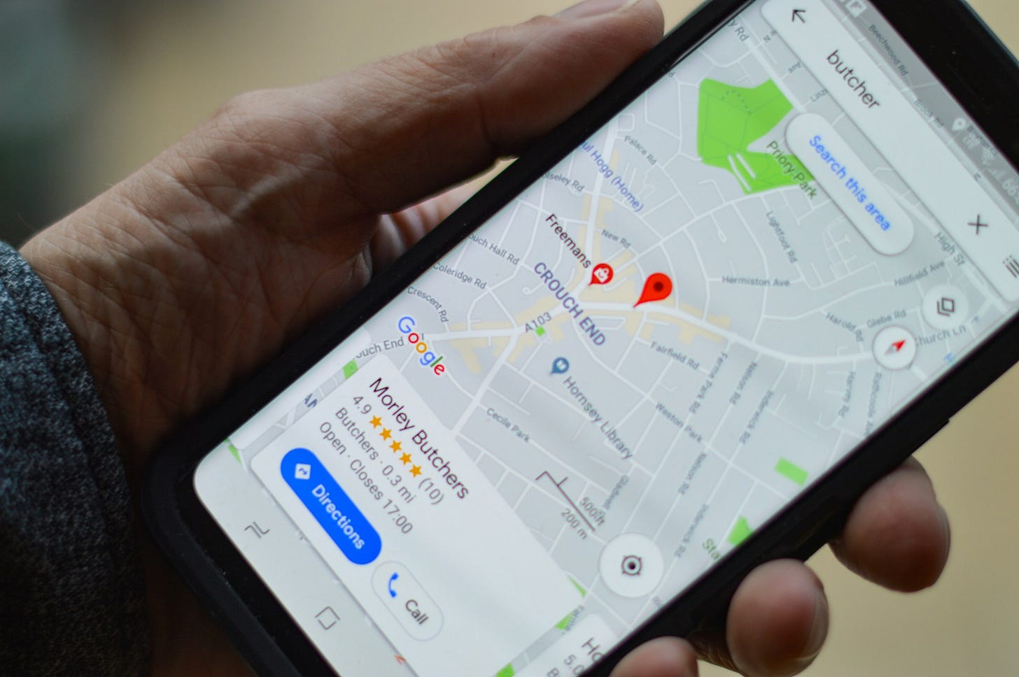 A hand holds a cellphone displaying a Google Map. Photo by Henry Perks on Unsplash