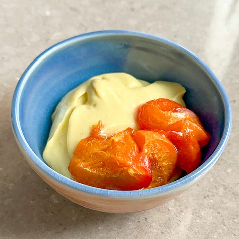 A bowl with chamomile pudding, a bowl with roasted apricots and chamomile pudding, a bowl with with roasted apricots and chamomile pudding topped with chopped pistachios.