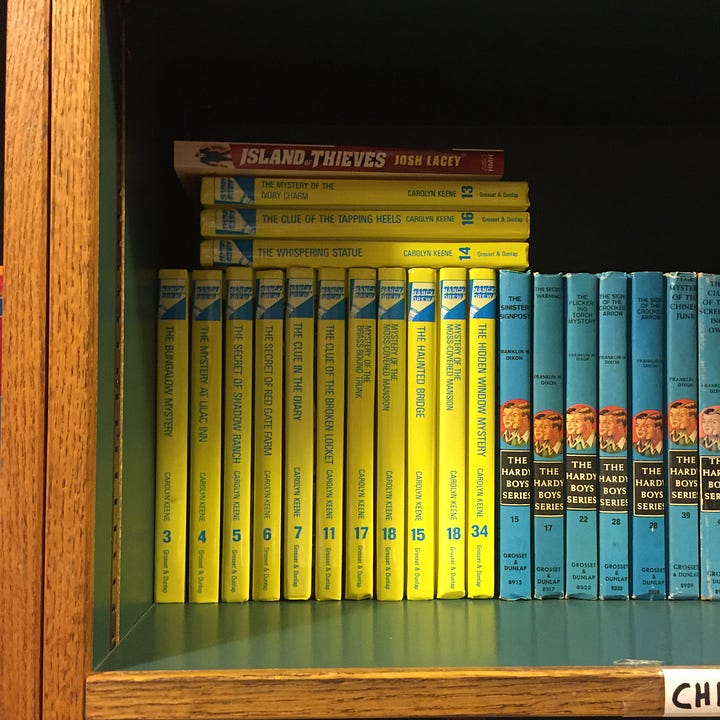 A row of Nancy Drew & Hardy Boys books + a Nancy Drew book cover Christmas tree ornament