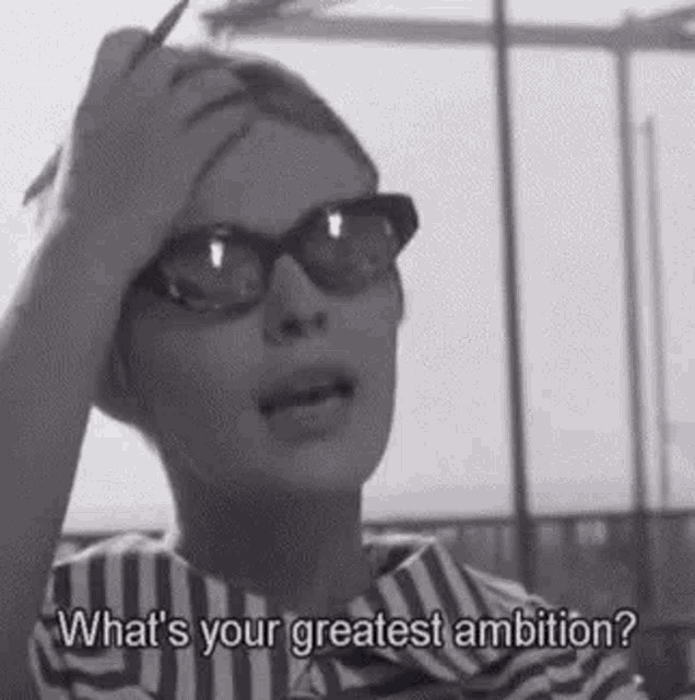 a woman wearing glasses and a striped shirt is holding her hand to her head and talking . a woman wearing glasses and a striped shirt is holding her hand to her head and talking .