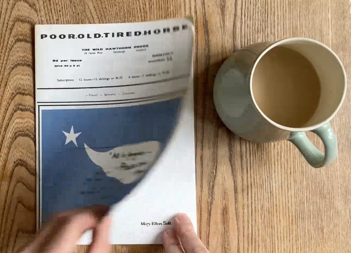 A person reading a newspaper next to a mug of coffee

AI-generated content may be incorrect.