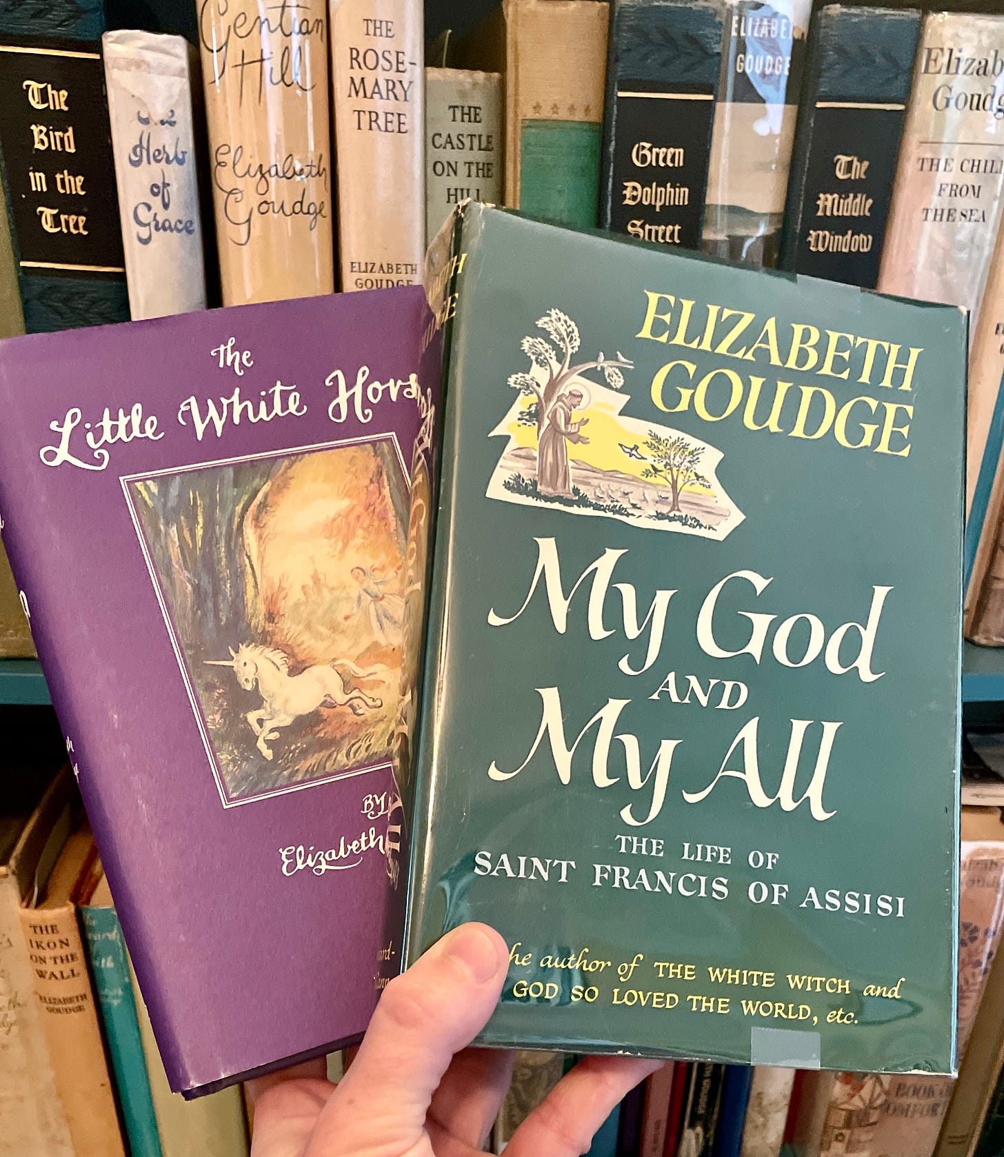 The Little White Horse and My God and My All by Elizabeth Goudge beside my Goudge bookcase. The Little White Horse and My God and My All by Elizabeth Goudge beside my Goudge bookcase.