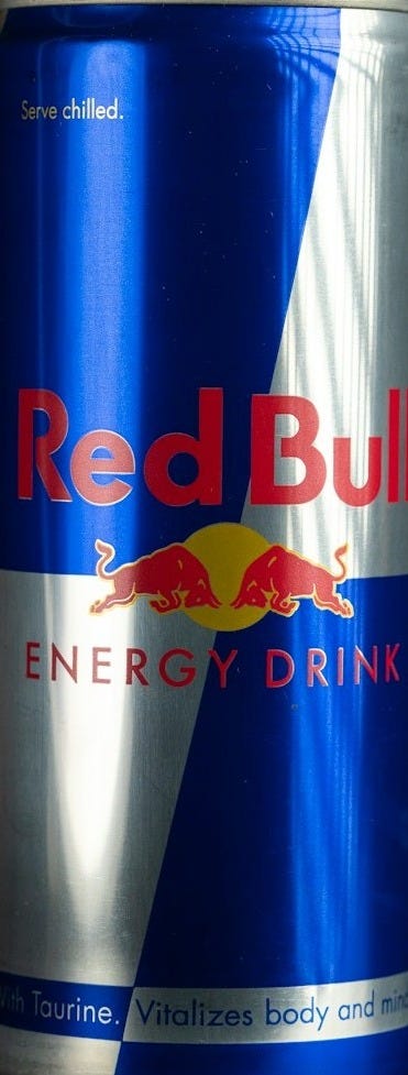 a can of red bull energy drink sitting on a table