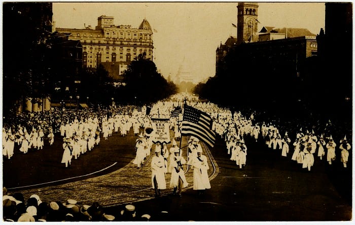 Photographic postcard of the Ku Klux Klan marching down Pennsylvania Avenue | National Museum of African American History and Culture Photographic postcard of the Ku Klux Klan marching down Pennsylvania Avenue | National Museum of African American History and Culture
