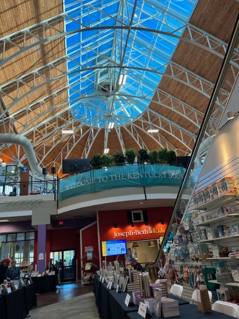 Escalators in the foreground and above, a vaulted ceiling with a large skylight