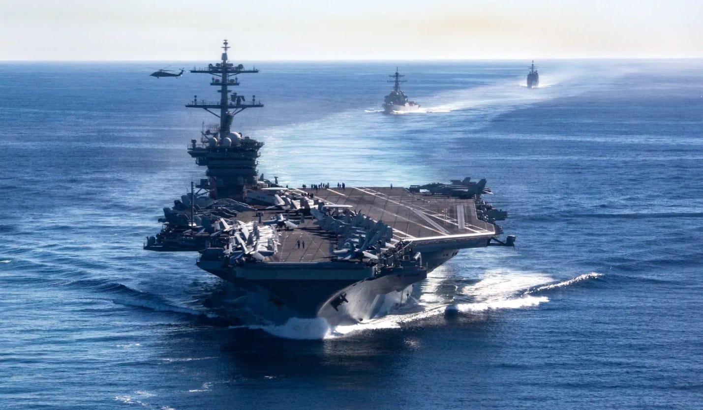 The aircraft carrier USS <i>Abraham Lincoln</i> (front), <i>Arleigh Burke</i>-class destroyer USS <i>Fitzgerald</i> (middle), and <i>Ticonderoga</i>-class cruiser USS <i>Mobile Bay</i>, assigned to Carrier Strike Group CSG-3, sail in formation in the Pacific Ocean, November 13, 2021. 