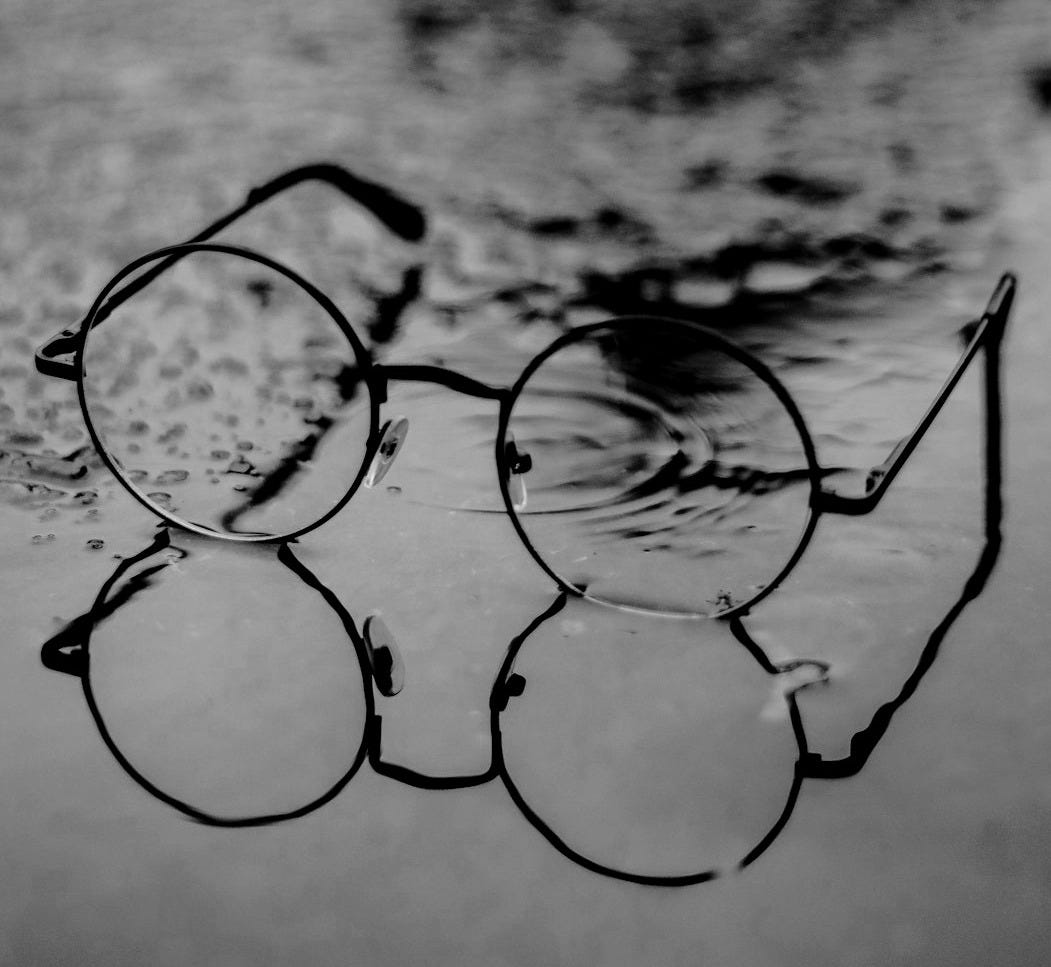 silver framed eyeglasses on white surface silver framed eyeglasses on white surface
