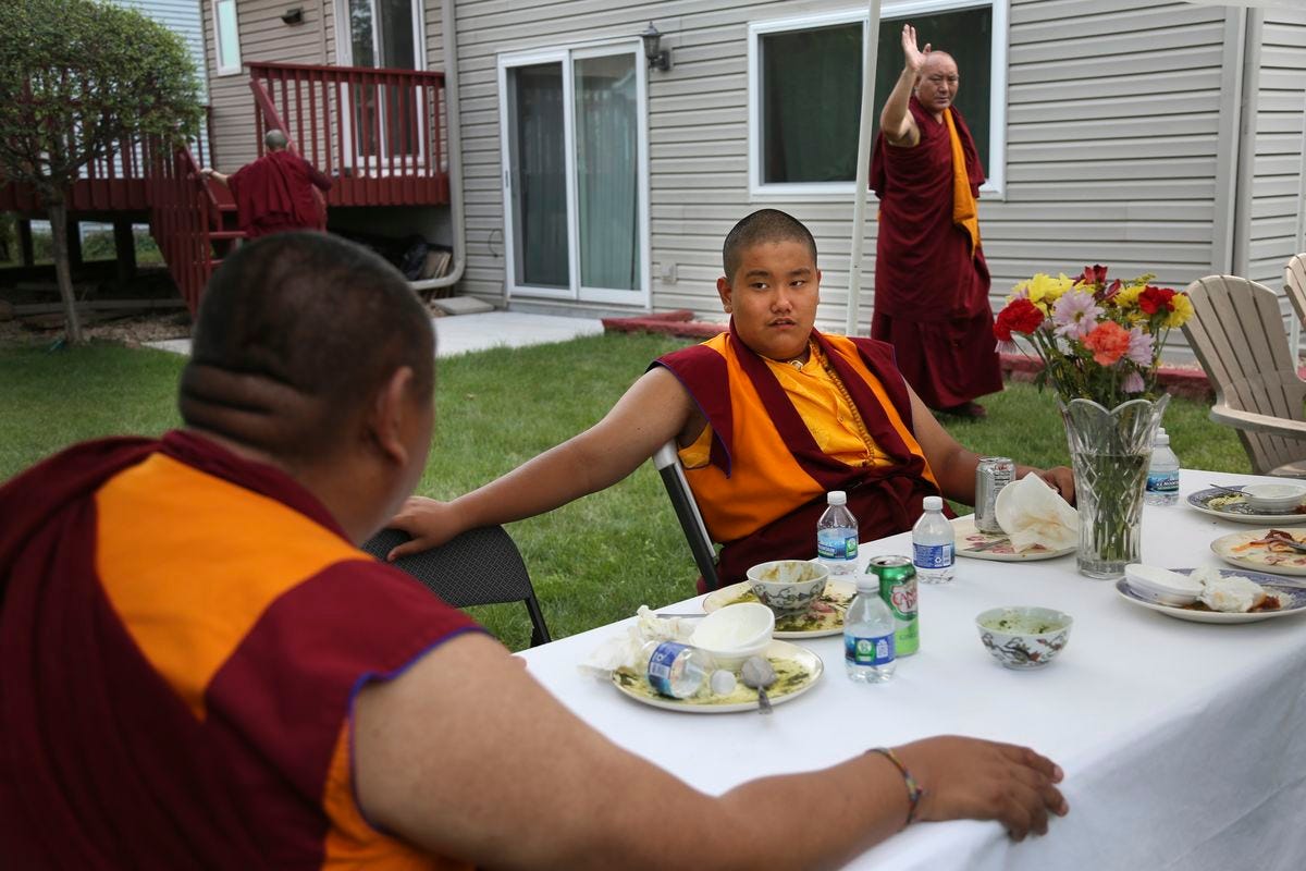 Tibetan Buddhism meditation and mentor Khenpo Kunga, left, talks with 14-year-old Buddhist lama Jalue Dorje after a dinner on Monday, July 19, 2021 in Columbia Heights, Minn., concluding a ceremony paying homage to Guru Rinpoche, the Indian Buddhist master who brought Tantric Buddhism to Tibet. (Jessie Wardarski) Tibetan Buddhism meditation and mentor Khenpo Kunga, left, talks with 14-year-old Buddhist lama Jalue Dorje after a dinner on Monday, July 19, 2021 in Columbia Heights, Minn., concluding a ceremony paying homage to Guru Rinpoche, the Indian Buddhist master who brought Tantric Buddhism to Tibet. (Jessie Wardarski)
