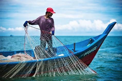 Fisherman With Net And Boat