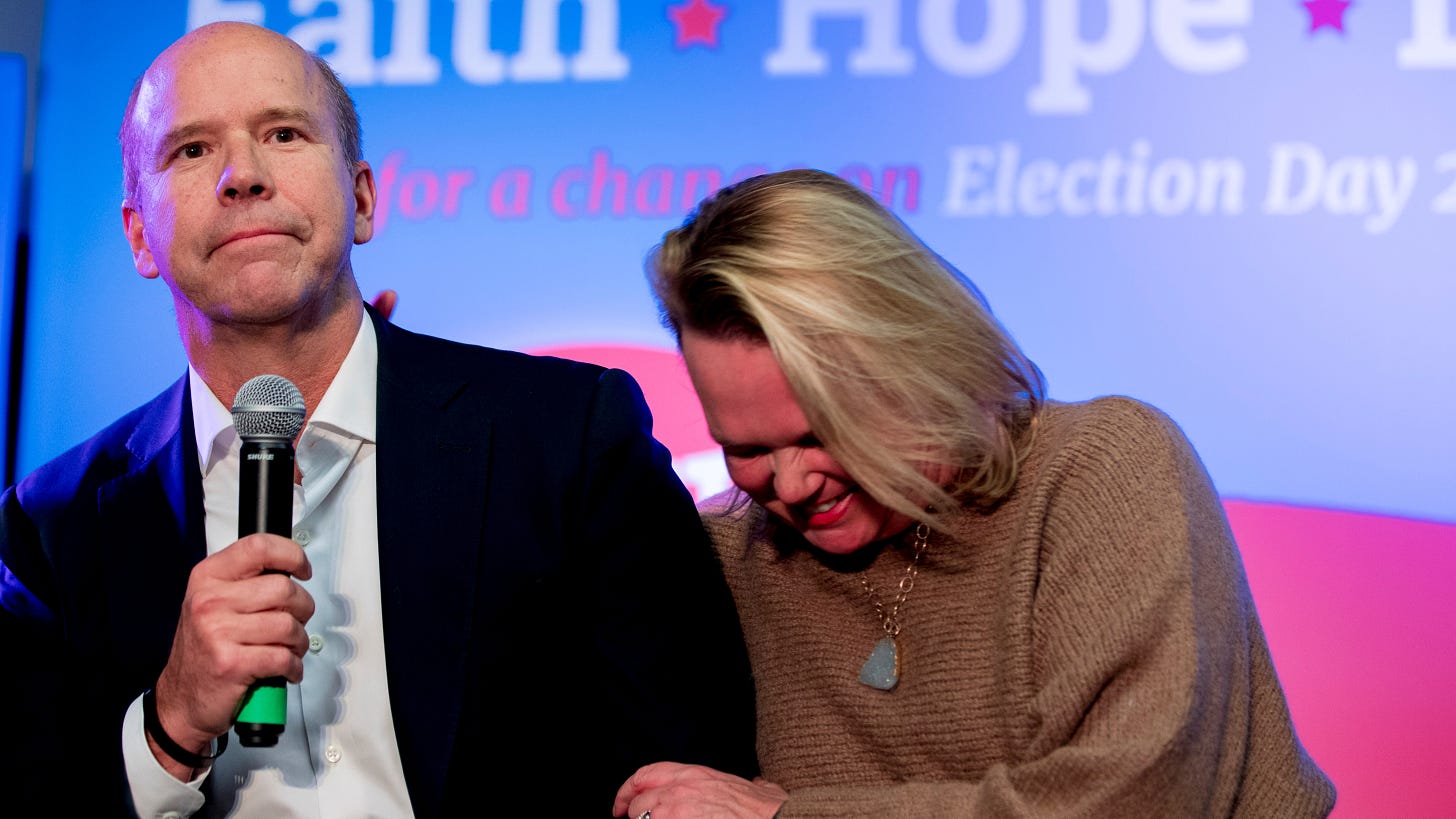 Then-Democratic presidential candidate former Maryland Rep. John Delaney, jokes with his wife, April McClain Delaney, right, as he speaks at the Faith, Politics and the Common Good Forum at Franklin Jr. High School in January 2020 in Des Moines, Iowa.