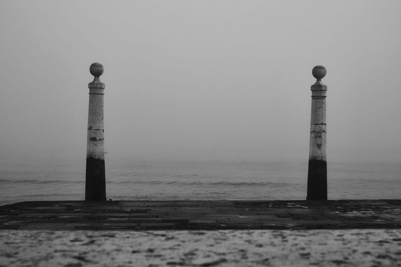 Black and white view of the Cais das Colunas in Lisbon, with fog over the river Tejo. Black and white view of the Cais das Colunas in Lisbon, with fog over the river Tejo.