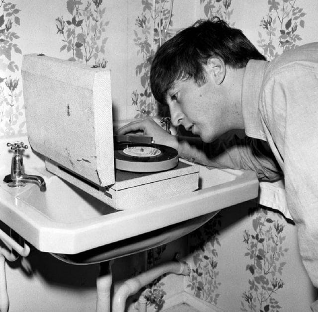 John Lennon listening to a pre-release test pressing of the " Twist and  Shout" EP on a portable record player in 1963. : r/beatles