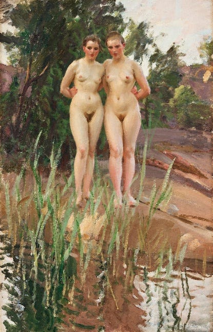 A vertical oil painting by Anders Zorn depicting two nude young women standing side by side on a muddy riverbank, their arms gently touching behind each other’s backs. They face forward, looking slightly downward at their reflections in the water. The foreground is filled with tall green reeds, and behind them, soft brushstrokes suggest rocks, trees, and the dappled light of a wooded setting. The scene conveys warmth, quiet closeness, and the harmony between figure and nature.