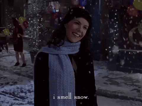 a girl smiling in the snow with the quote i smell snow