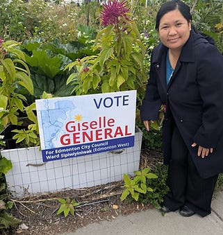 Giselle holding a lawn sign. 2.jpg