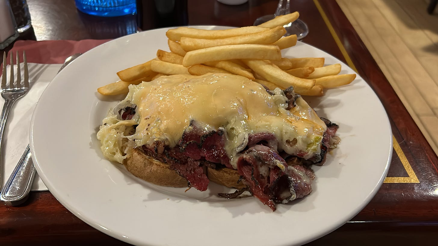 A gigantic open-faced Reuben and fries
