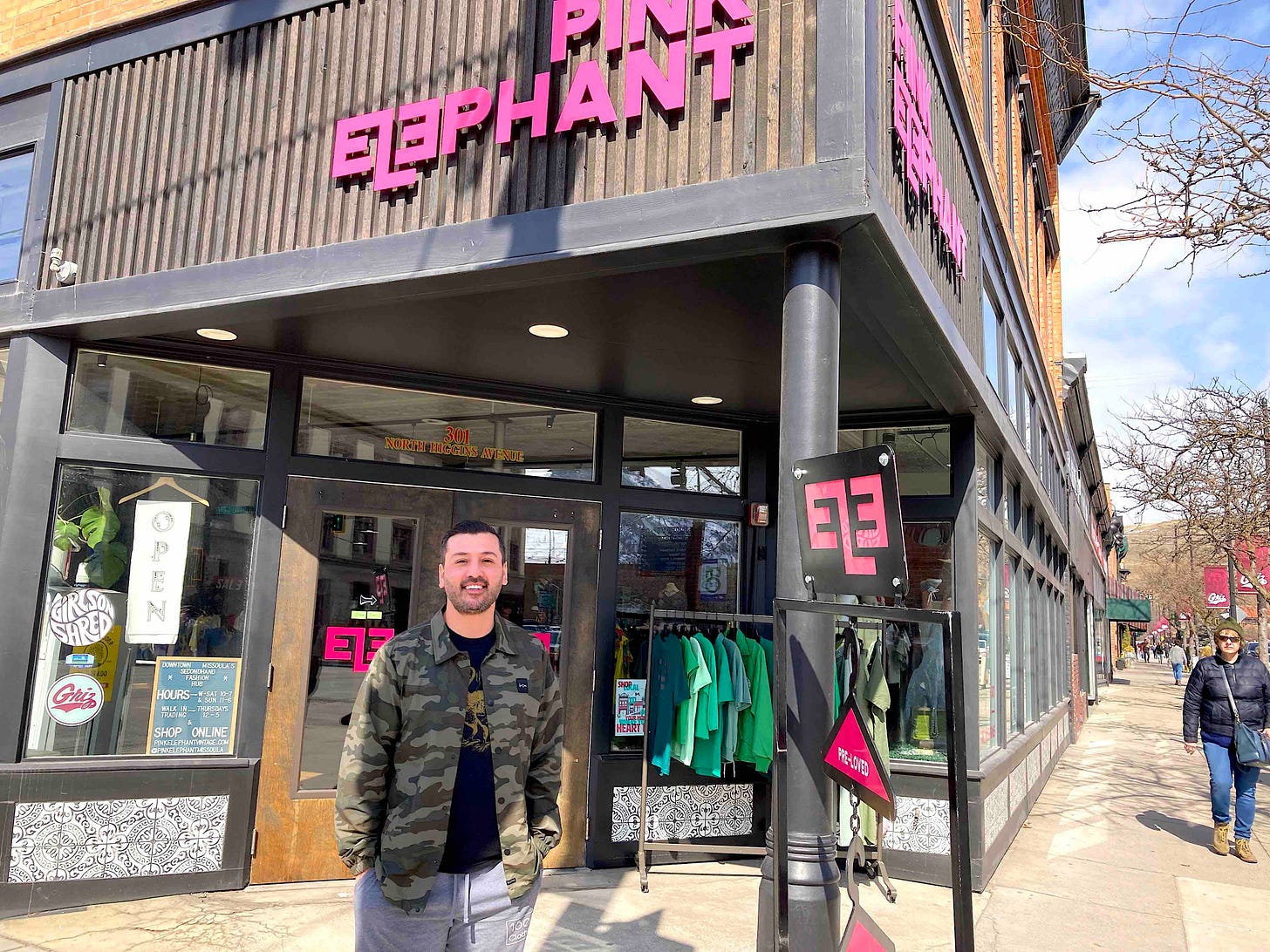 man in front of store on corner