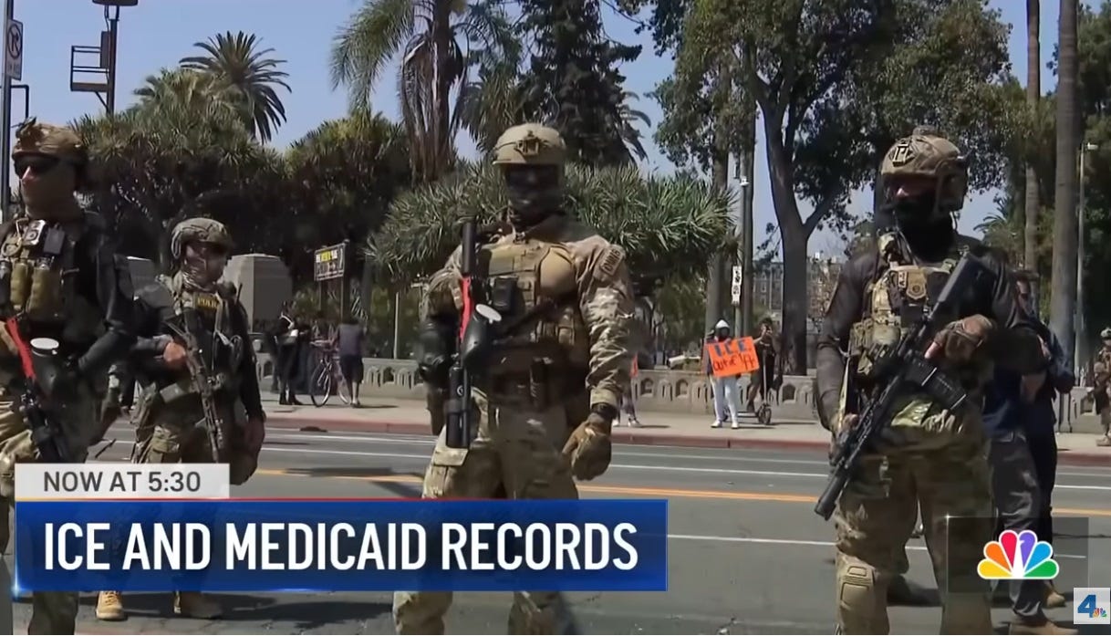 Video screenshot of masked ICE officers in military gear carrying assault rifles on a palm-tree lined street in California. Chyron reads 'ICE AND MEDICAID RECORDS' Video screenshot of masked ICE officers in military gear carrying assault rifles on a palm-tree lined street in California. Chyron reads 'ICE AND MEDICAID RECORDS'