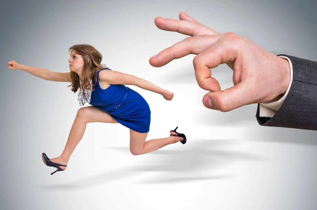 Woman running away from male hand flicking her out
